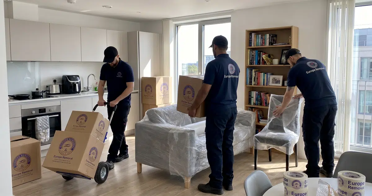 Removal workers packing a modern apartment