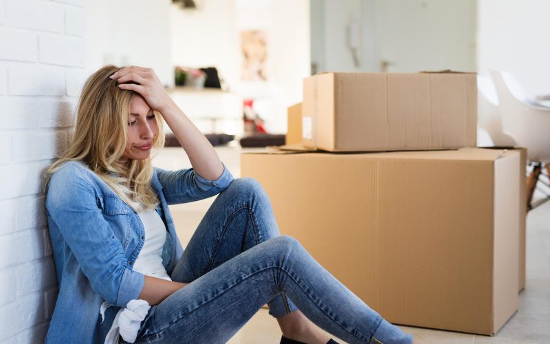 tired-woman-exhausted-while-moving-into-new-home-SB84W23.jpg